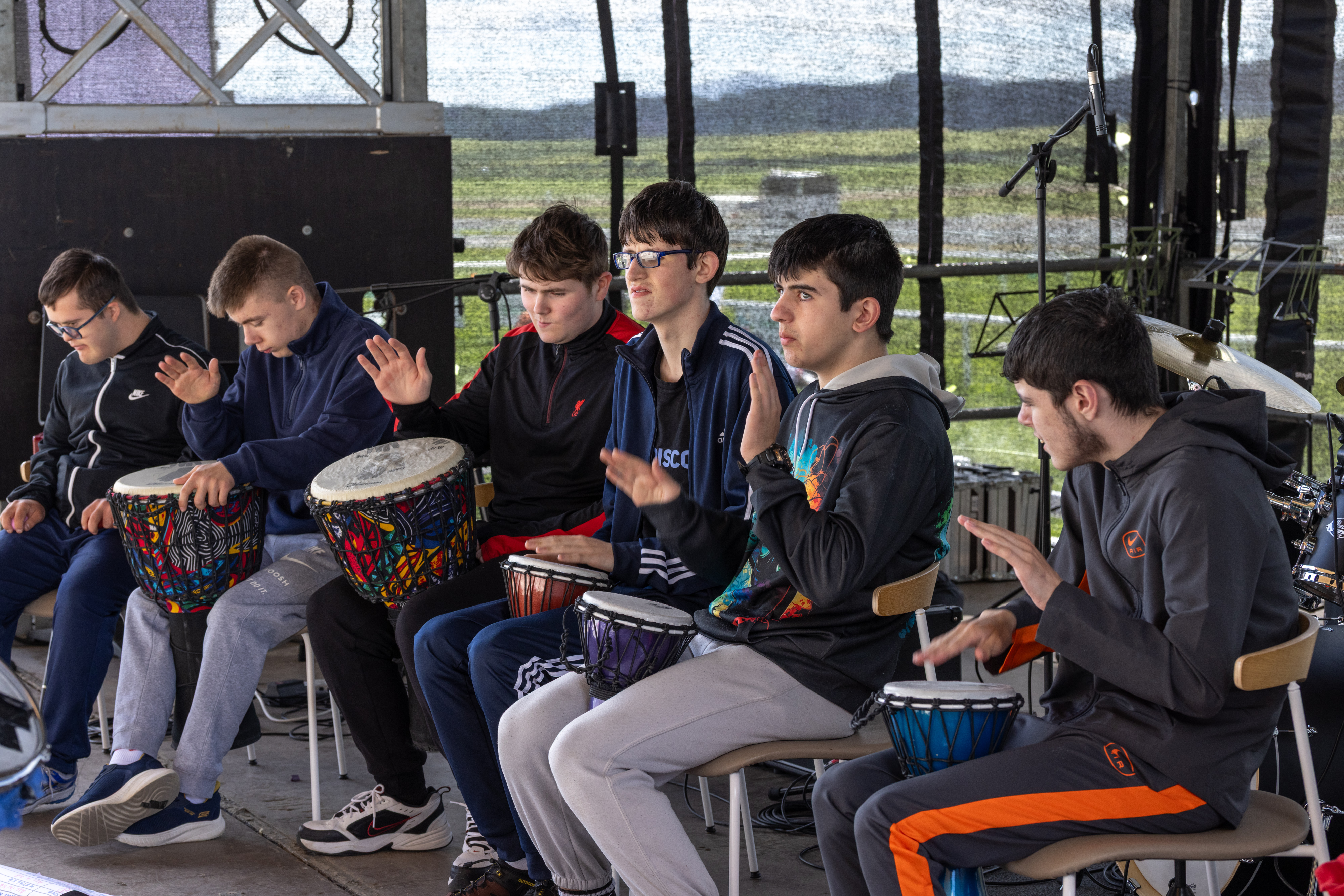 People playing drums on stage. 